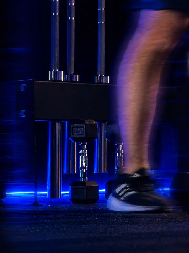 A user pressing the leg machine with one leg extended in motion