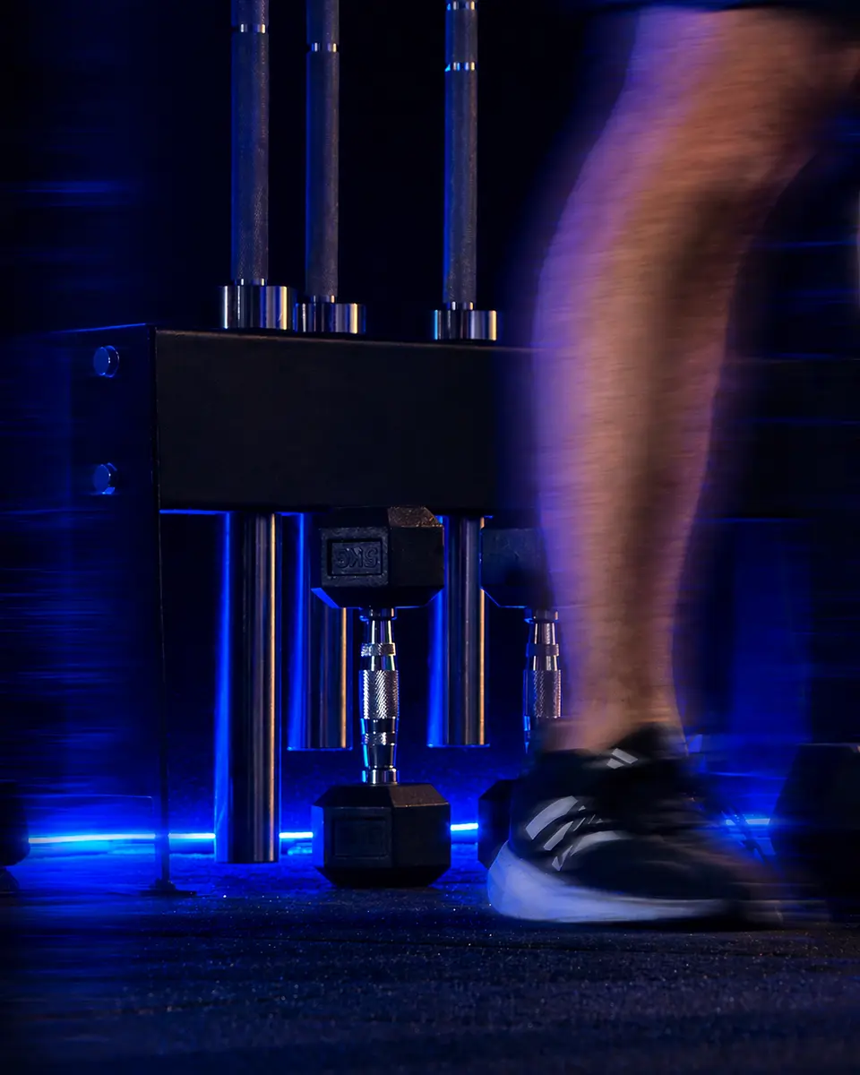 A user pressing the leg machine with one leg extended in motion