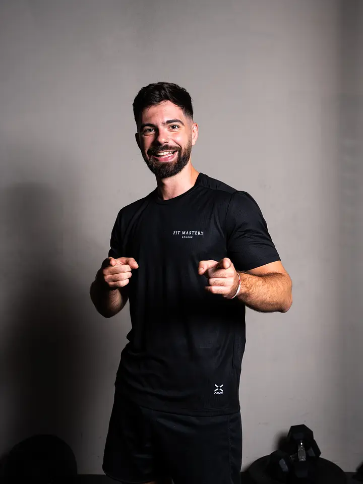 A person wearing black athletic kit pointing towards the camera
